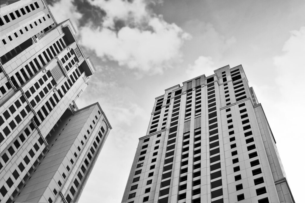 Tall skyscraper buildings from below in black and white