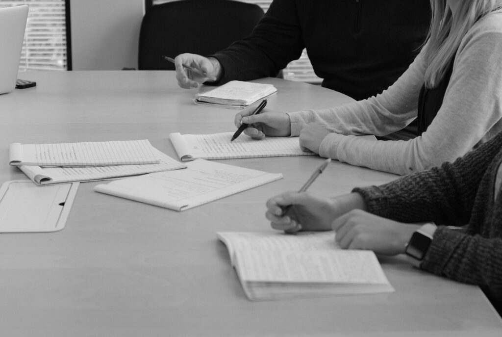 lawyers sitting at meeting desk in black and white